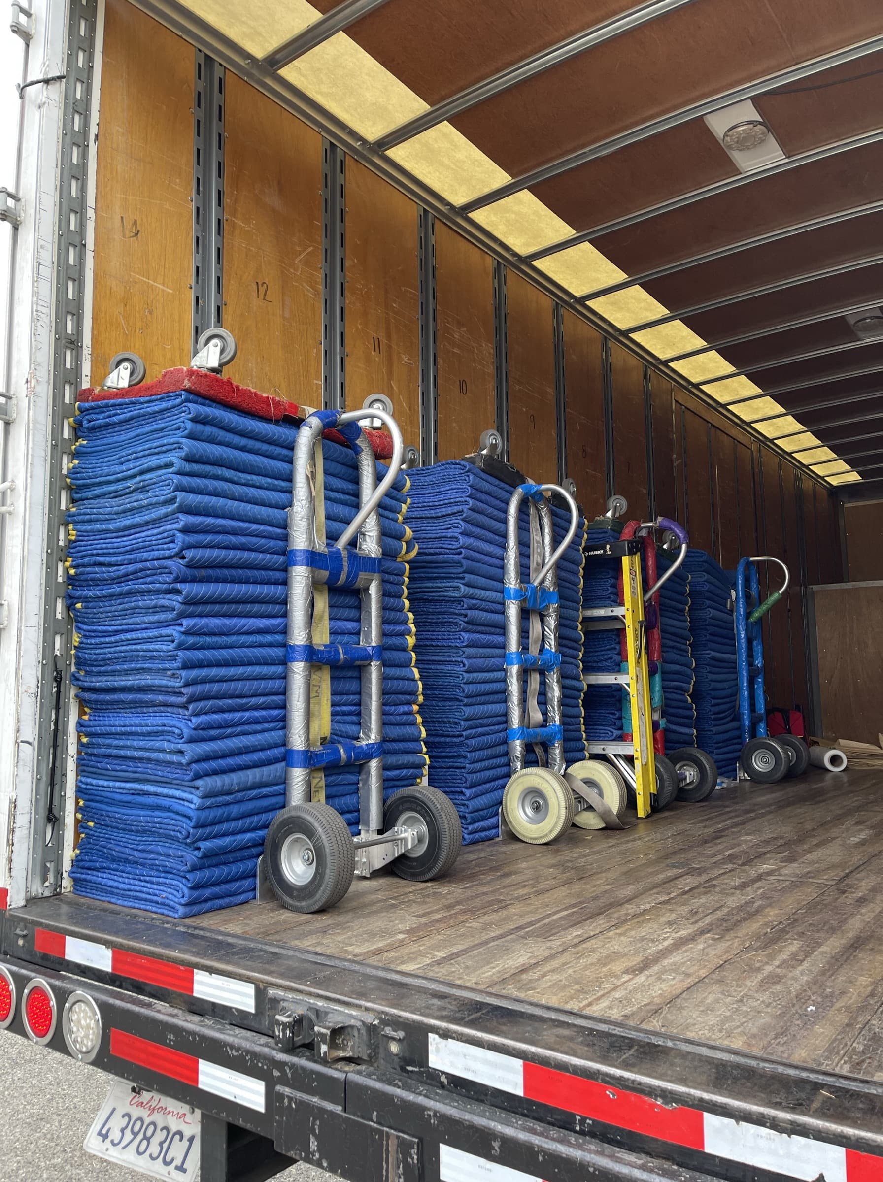 Silicon Valley Moving & Storage padded hand trucks and moving equipment staged at the truck, ready for a Bay Area campus and office relocation