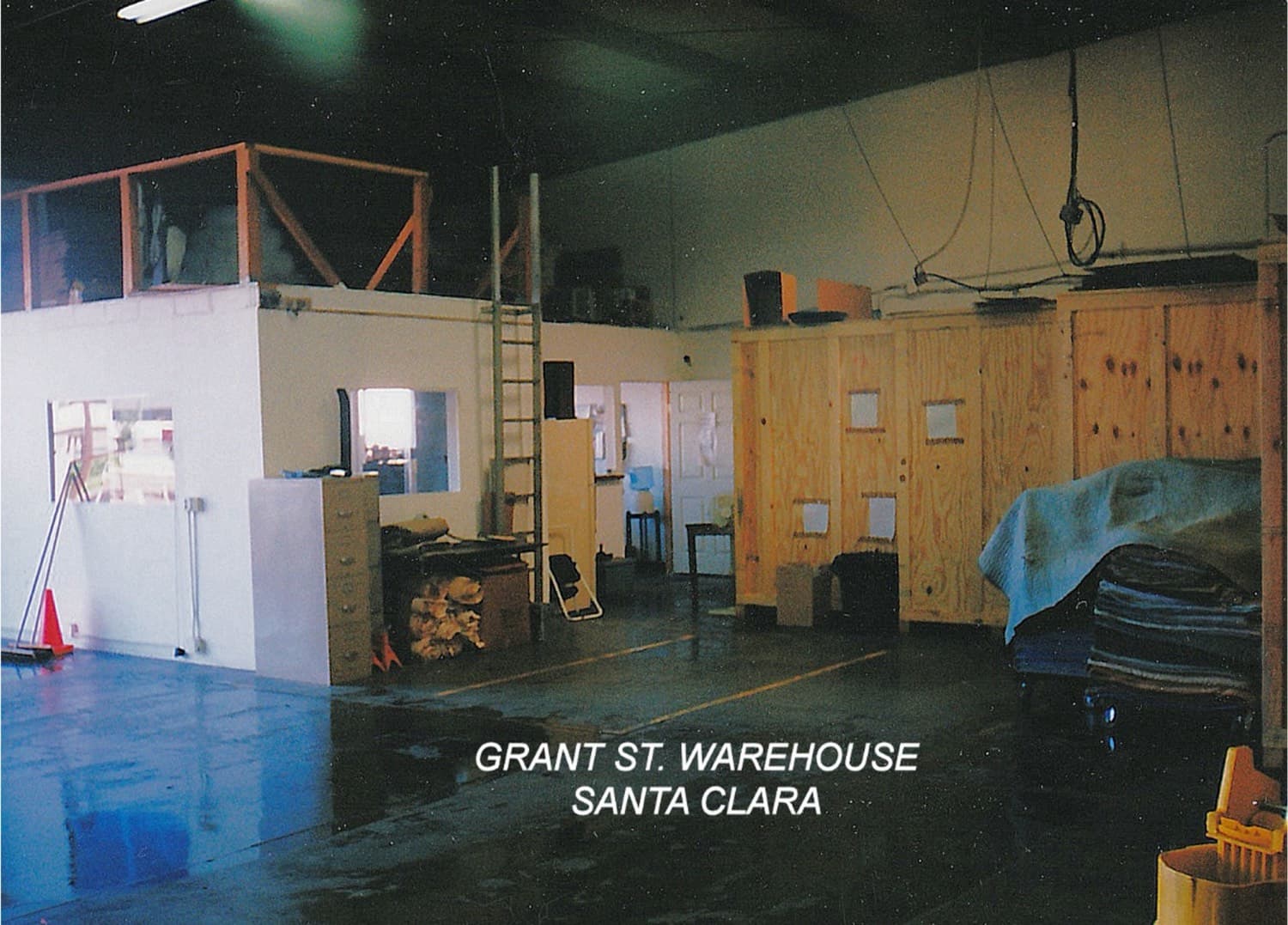 Inside the original Silicon Valley Moving & Storage warehouse on Grant Street in Santa Clara, showing wooden crating and storage vaults from the 1990s